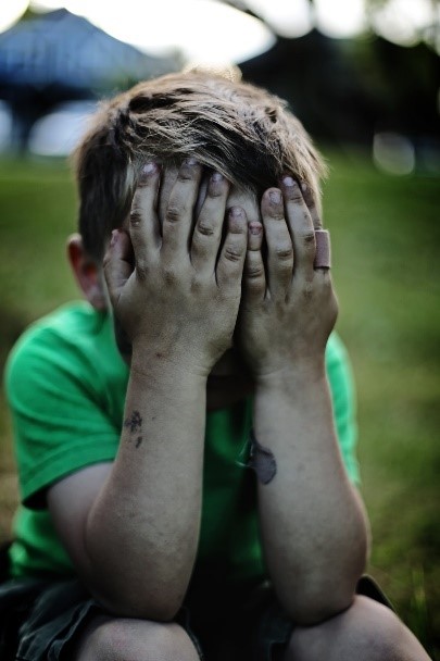 child covering eyes due to sensory overload